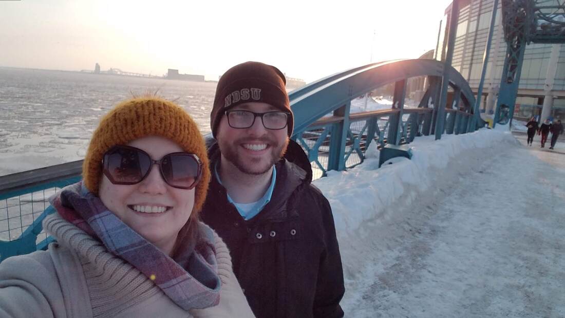 Christine and Adam in front of Duluth bridge, snowy scene